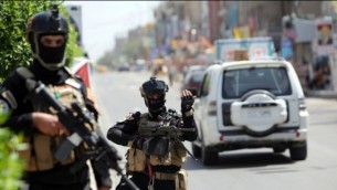 أعضاء القوة العراقية لمكافحة الارهاب الحراسة خارج مركز اقتراع في العاصمة بغداد يوم 29 أبريل 2014  ( AFP/Ahmad al-Rubaye)