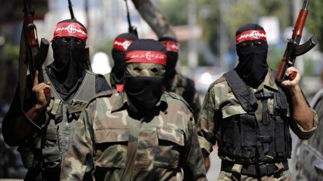 مقاتلوا الشعبية لتحرير فلسطين اثناء مؤتمر صحفي في مدينة غزة  27 أغسطس، 2014. AFP PHOTO / MOHAMMED ABED
