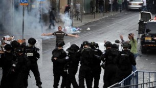 صورة توضيحية لأحد المتظاهرين امام الشرطة الإسرائيلية خلال اشتباكات في القدس الشرقية AFP/ AHMAD GHARABLI