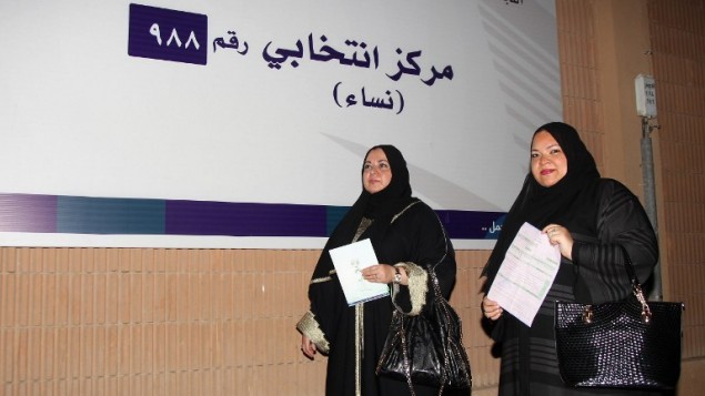 سيدتان سعوديتان تحملان طلبات التسجيل خلال توجههما لتسجيل إسميهما للإقتراع  في مدينة جدة الساحلية في 30 أغسطس، 2015.  (AFP PHOTO / STR)