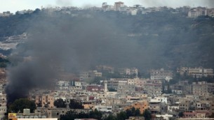الدخان يتصاعد من مخيم عين الحلوة للاجئين الفلسطينيين القريب من مدينة صيدا الساحلية جنوب لبنان خلال  إشتباكات في 25 أغسطس، 2015. (Mahmoud Zayyat/ AFP)