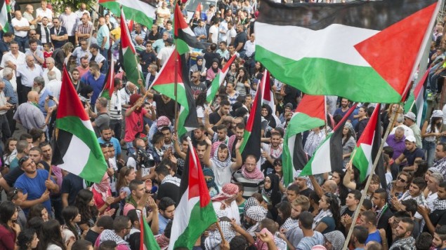 Arab Israelis hold Palestinian flags during in a large demonstration as part of a general strike organised to support the Palestinians who call for a "day of rage" on October 13, 2015 in the northern Arab-Israeli town of Sakhnin. AFP PHOTO / JACK GUEZ Arab Israelis hold Palestinian flags during in a large demonstration as part of a general strike organised to support the Palestinians who call for a "day of rage" on October 13, 2015 in the northern Arab-Israeli town of Sakhnin. AFP PHOTO / JACK GUEZ