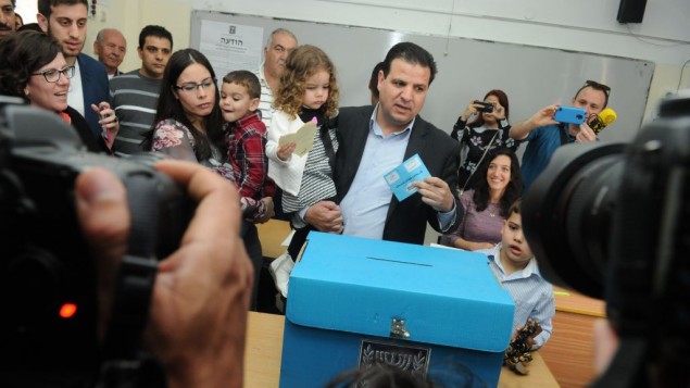 ايمن عودة، رئيس القائمة المشتركة يدلي بصوته برفقة ثلاثة اطفاله في الناصرة، 17 مارس 2015 (Basal Awidat/Flash90)