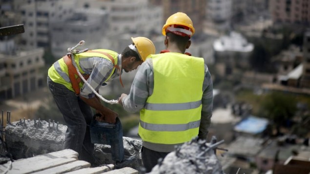 عمال فلسطينيون يزيلون الحطام من مبنى في غزة دمر خلال حرب 2014 بين حماس واسرائيل، 5 ابريل 2016 (MOHAMMED ABED / AFP)