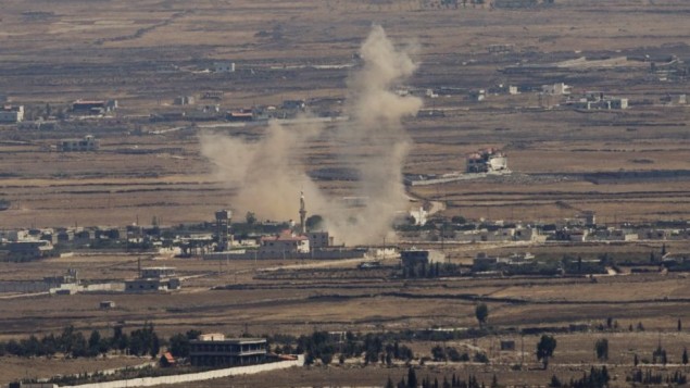Smoke rises following an explosion in Syria's Quneitra province as Syrian rebels clash with President Bashar Assad’s forces, seen from the Israeli-controlled Golan Heights in 2014. AP/Ariel Schalit, File