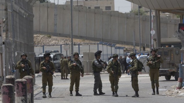 Israeli security forces at the main entrance of the Qalandiya checkpoint, a key crossing point between Jerusalem and the West Bank city of Ramallah, Wednesday, April 27, 2016. (AP Photo/Nasser Nasser) Israeli security forces at the main entrance of the Qalandiya checkpoint, a key crossing point between Jerusalem and the West Bank city of Ramallah, Wednesday, April 27, 2016. (AP Photo/Nasser Nasser)