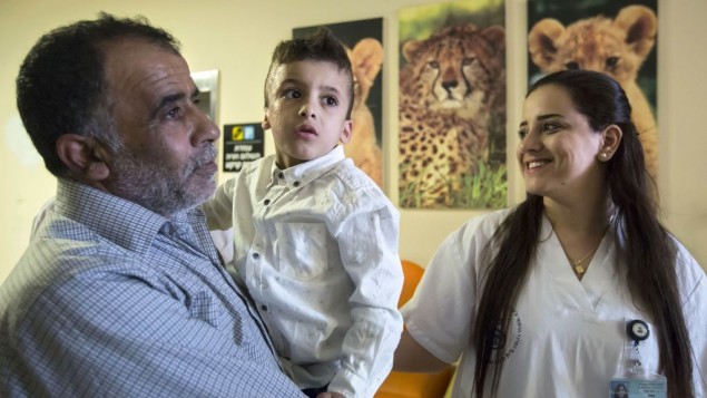 Ahmad Dawabsha, the sole survivor of a West Bank arson attack in Duma village, is carried by his grandfather Hussein at the Tel HaShomer Hospital in the city of Ramat Gan, Israel, Friday, July 22, 2016. AP Photo/Tsafrir Abayov