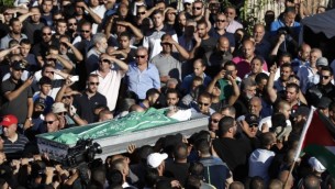 المشيعون يحملون جثمان محمد طه، الذي قُتل خلال مواجهات عندما حاول متظاهرون إقتحام محطة للشرطة فجرا، خلال جنازته في مدينة كفر قاسم العربية في وسط إسرائيل، 6 يونيو، 2017. (AFP/Ahmad GHARABLI) المشيعون يحملون جثمان محمد طه، الذي قُتل خلال مواجهات عندما حاول متظاهرون إقتحام محطة للشرطة فجرا، خلال جنازته في مدينة كفر قاسم العربية في وسط إسرائيل، 6 يونيو، 2017. (AFP/Ahmad GHARABLI)