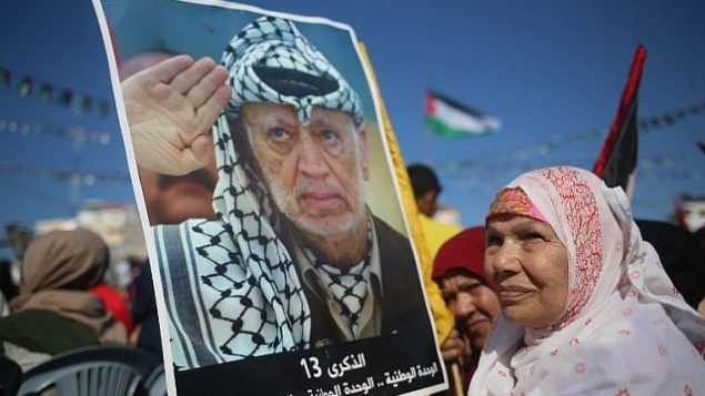 فلسطينيون يحملون صورا للزعيم الراحل ياسر عرفات في مدينة غزة في 9 نوفمبر، 2017، خلال مهرجات لإحياء الذكرى ال13 لوفاته. (AFP PHOTO / MOHAMMED ABED)