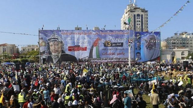 فلسطينيون يحملون صورا للزعيم الراحل ياسر عرفات في مدينة غزة في 9 نوفمبر، 2017، خلال مهرجات لإحياء الذكرى ال13 لوفاته. صورة للزعيم الروحي الراحل لحركة ’حماس’ الشيخ أحمد ياسين تظهر على يمين الصورة. (AFP PHOTO / MOHAMMED ABED)