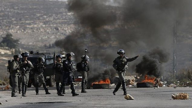 القوات الإسرائيلية خلال اشتباكات مع متظاهرين فلسطينيين في بتونيا في الضفة الغربية، 7 ديسمبر 2017 (AFP PHOTO / ABBAS MOMANI)