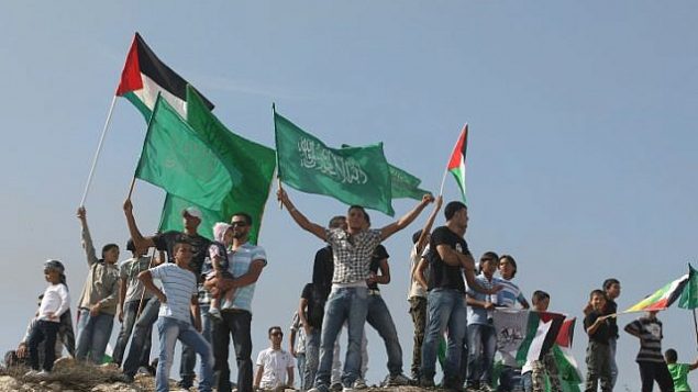 فلسطينيون يلوحون بأعلام حماس وهم يحتفلون باتفاق تبادل الأسرى الذي تم التوصل إليه بين إسرائيل وحماس في القدس الشرقية 18 أكتوبر 2011. (Kobi Gideon / Flash90)