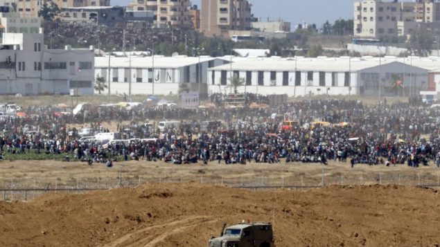 متظاهرون فلسطينيون يتجمعون عمد السياج الحدودي مع اسرائيل، 14 مايو 2018 (JACK GUEZ/AFP)