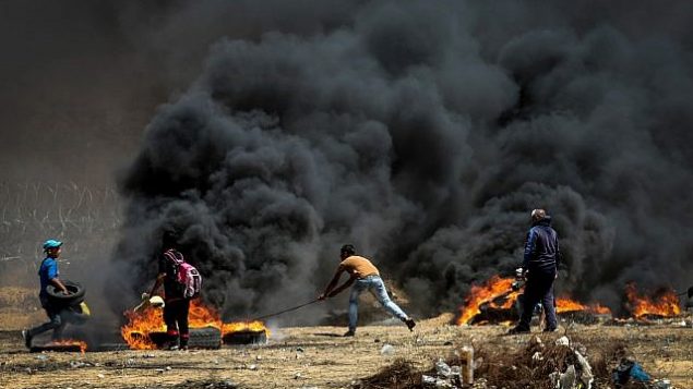 متظاهرون فلسطينيون خلال مواجها مع القوات الإسرائيلية عند حدود غزة، شرقي مدينة غزة، 11 مايو، 2018. (Abed Rahim Khatib/Flash90)