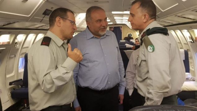 وزير الدفاع افيغادور ليبرمان يتحدث مع سكرتيره العسكري الجنرال يئير كوهلز (يسار) ومدير الاستخبارات العسكرية الجنرال تامير هايمان (يمين) على متن طائرة بطريقها الى روسيا، 20 مايو 2018 (Ariel Hermoni/Defense Ministry)