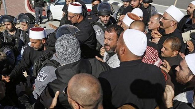 قوى الأمن الإسرائيلي تقف للمراقبة خلال مظاهرة لرجال دروز ضد الإنتخابات المحلية أمام مركز إقتراع في قرية مجدل شمس في هضبة الجولان، 30 أكتوبر، 2018.   (Photo by JALAA MAREY / AFP)