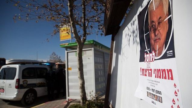 A poster showing Palestinian President Mahmud Abbas with a text reading “Eliminate the sponsers of murder” is hanging on a bus station at the entrance to the Israeli settlement of Adam, in the central West Bank on December 11, 2018. (Yonatan Sindel/Flash90) A poster showing Palestinian President Mahmud Abbas with a text reading “Eliminate the sponsers of murder” is hanging on a bus station at the entrance to the Israeli settlement of Adam, in the central West Bank on December 11, 2018. (Yonatan Sindel/Flash90)