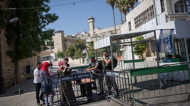 توضيحية: شرطة حرس الحدود تقوم بفحص هويات نساء فلسطينيات عند مدخل الحرم الإبراهيمي في مدينة الخليل بالضفة الغربية، 9 يوليو، 2017. (Miriam Alster/Flash90)