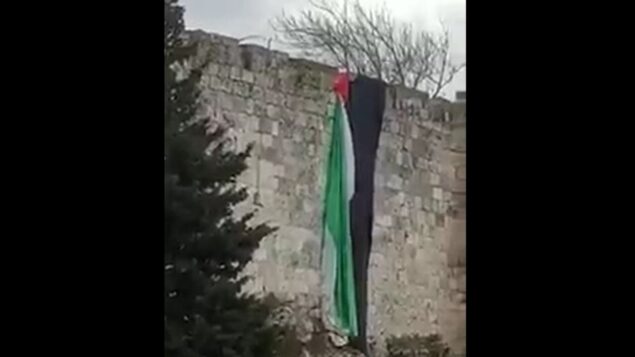 علم فلسطيني معلق على ن جدران القدس القديمة، 1 يناير 2020. (screen capture: Twitter)