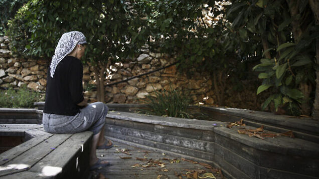 An Orthodox Jewish woman sits in the garden of the abused women's shelter in Beit Shemesh, July 15, 2014. The shelter is a home for women who have suffered physical abuse from their husbands, and their children. Photo by Hadas Parush/Flash90 *** Local Caption *** î÷ìè ðùéí
ðùéí îåëåú
éìãéí
áéú ùîù
ãúéåú
éäåãéåú