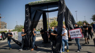 أصحاب صالات المناسبات في إسرائيل يحتجون خارج مكتب رئيس الوزراء في القدس مع عريشة زواج سوداء، 26 يوليو 2020 (Yonatan Sindel / Flash90)