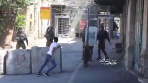 لقطة من مقطع فيديو يظهر شابا فلسطينيا يرشق الحجارة على جنود الجيش الإسرائيلي في الخليل من مسافة قصيرة، 29 أغسطس 2020 (video screenshot)