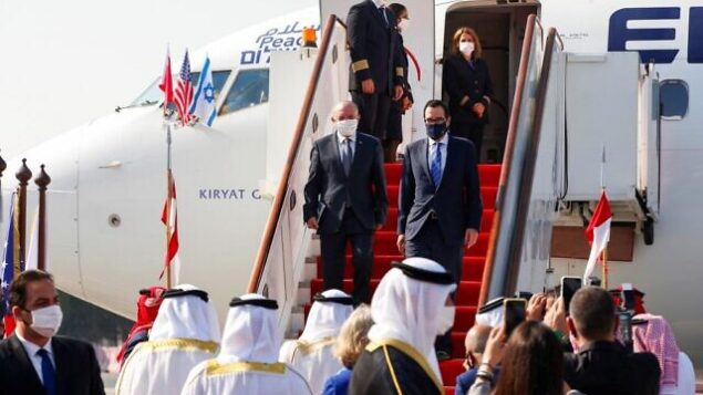مستشار الأمن القومي مئير بن شبات (يسار) ووزير الخزانة الأمريكي ستيف منوشين ينزلان من طائرة لدى وصولهما مطار البحرين الدولي، 18 أكتوبر، 2020. (Ronen Zvulun / Pool / AFP)