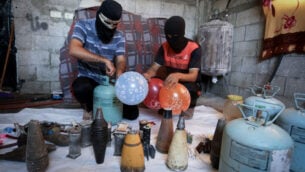 فلسطينيون في مدينة رفح جنوب غزة يعدون بالونات حارقة لإطلاقها باتجاه إسرائيل، 8 أغسطس 2020 (Abed Rahim Khatib / Flash90)