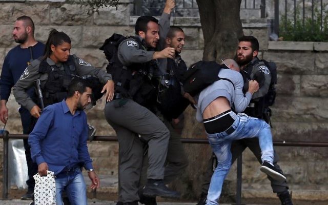 Border Police officers scuffle with a Palestinian protester as they detain him near Damascus Gate outside Jerusalem's Old City. Border Police officers scuffle with a Palestinian protester as they detain him near Damascus Gate outside Jerusalem's Old City.