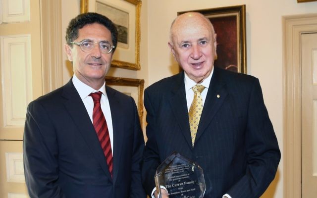 Charles Curran (right) with a memento presented by Allan Vidor (left), thanking the Curran family for its support. Photo: Noel Kessel