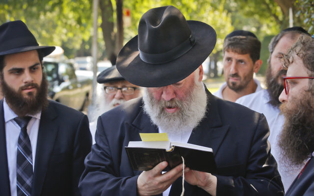 Norman Rosenbaum recites memorial prayers last week at the site where his brother Yankel Rosenbaum was stabbed during the 1991 Crown Heights riots.
Photo: AP Photo/Bebeto Matthews.