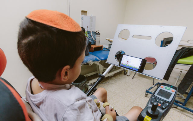 Israeli youngster Ori Shemesh using a touch free smartphone developed by Sesame Enable. Photo: Basti Hansen.