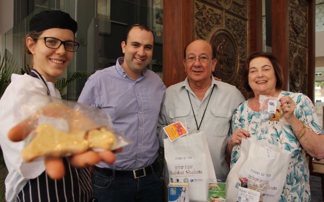 From left: Pastry chef Noa Nisell and her husband, JNF's education shaliach Yigal Nisell, present Purim mishloach manot packages to Mark Moran Vaucluse Seniors Living residents Bert and Dinah Danon on March 10.