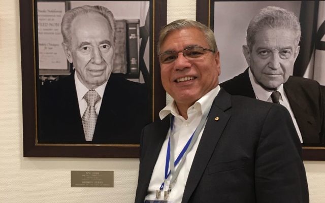 Nyunggai Warren Mundine during
a recent trip to Israel, in front of portraits of former presidents Shimon Peres and Ezer Weizman.