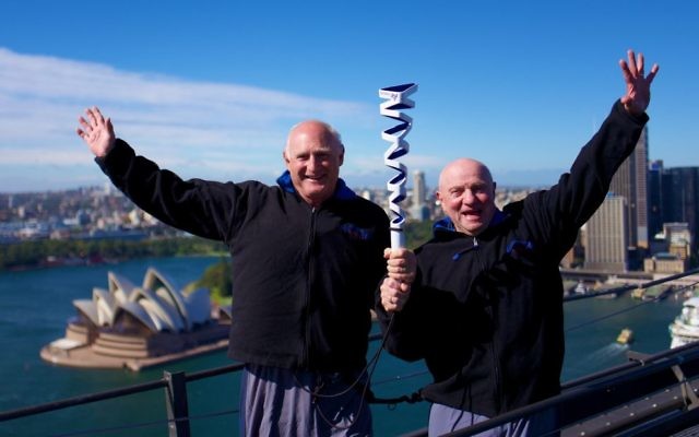 Maccabi Australia president Barry Smorgon (left) with the Australian Maccabiah team's head of delegation Tom York on Sydney Harbour Bridge with the Maccabiah torch. Photo: Robi Karp Maccabi Australia president Barry Smorgon (left) with the Australian Maccabiah team's head of delegation Tom York on Sydney Harbour Bridge with the Maccabiah torch. Photo: Robi Karp