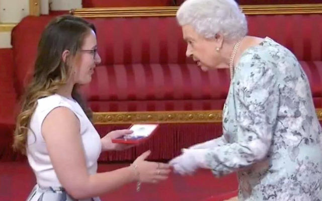 Madeleine Buchner receiving her award from Queen Elizabeth at Buckingham Palace.