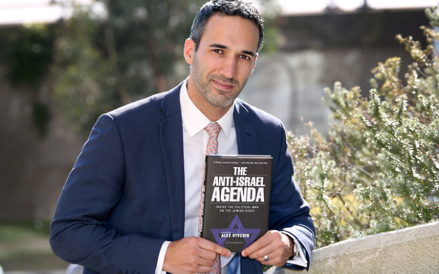 Alex Ryvchin with his new book. Photo: Noel Kessel.