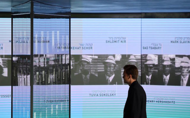 A visitor looks at the portraits of the murdered Israeli athletes displayed inside the Memorial Centre. Photo: Christof Stache/AFP/Getty Images