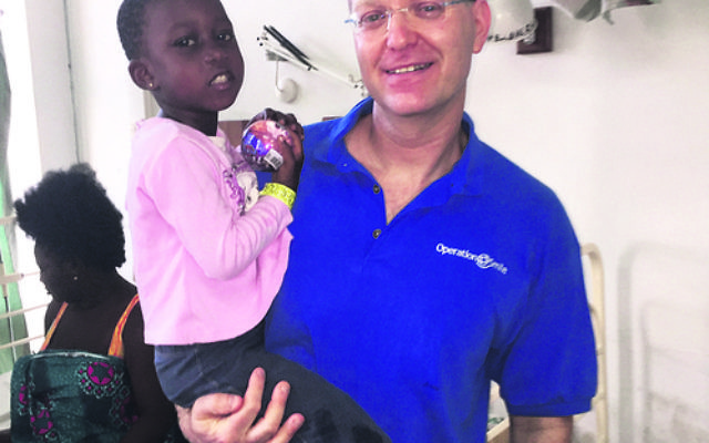 Omri Emodi with one of his patients. Omri Emodi with one of his patients.