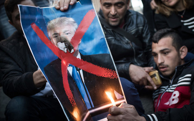 Protesters burn a poster of Donald Trump in front of the Damascus Gate on Monday. Photo: Chris McGrath/Getty Images Protesters burn a poster of Donald Trump in front of the Damascus Gate on Monday. Photo: Chris McGrath/Getty Images