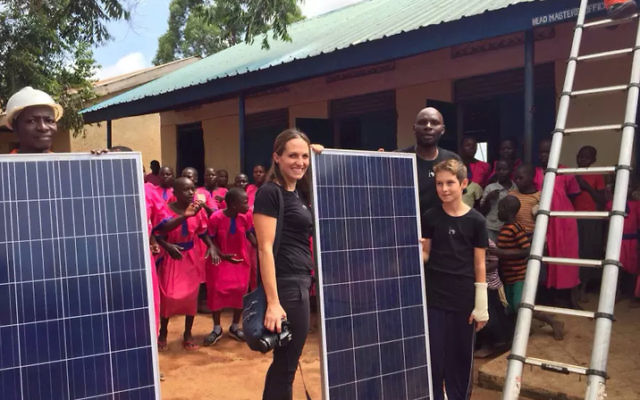 Liza with Eytan, with the solar panels at Bukalikha Primary School.