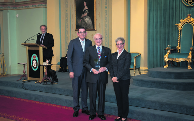 Paul Zimmet (centre) receiving his Victorian award from Premier Daniel Andrews and Governor Linda Dessau last October.