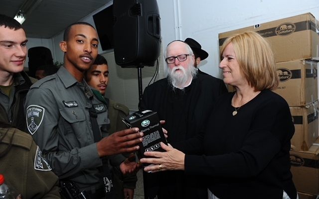 Saul Spigler (second from right) and his wife Beverly gifting thermal clothing to soldiers in Hebron.
