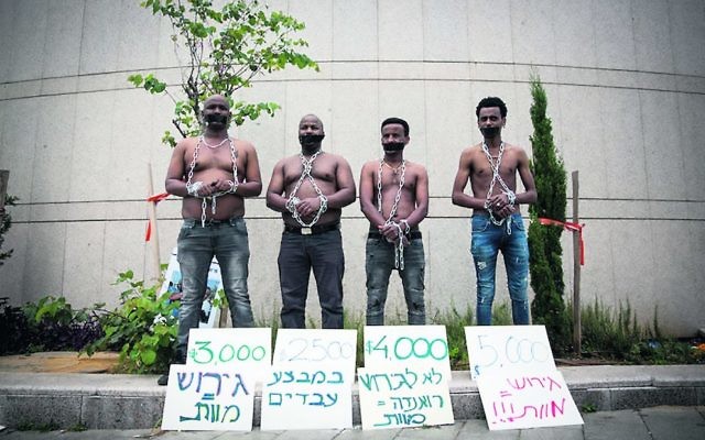 African asylum seekers set up a mock slave auction as part of a protest outside the Ministry of Defence on Tuesday. Photo: Miriam Alster/Flash90 African asylum seekers set up a mock slave auction as part of a protest outside the Ministry of Defence on Tuesday. Photo: Miriam Alster/Flash90