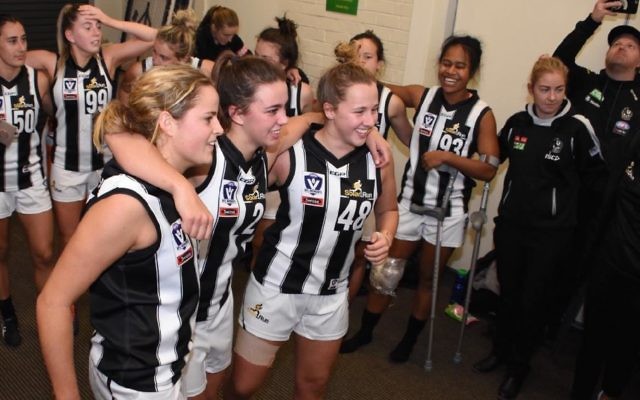 Ally Bild (right, no.48) in the winners' circle after her first VFLW game for Collingwood.Photo: Luke Henry - LH Photography