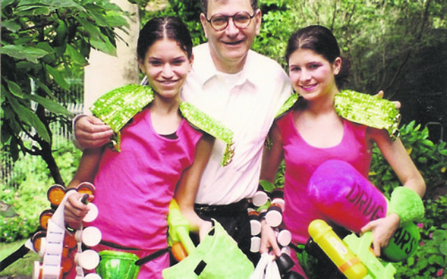 Professor David Cooper, who has been appointed as a Companion of the Order of Australia (AC), is pictured with his daughters Ilana and Becky at the 1999 Mardi Gras.