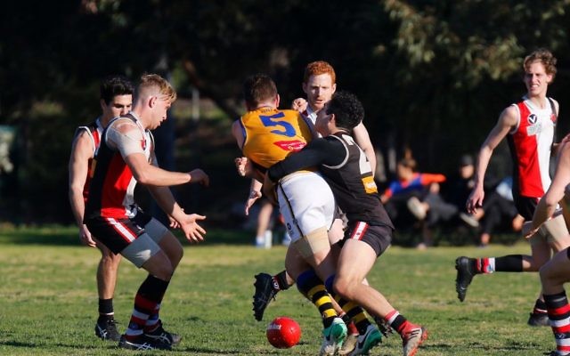 Charlie Hamilton tackles former Carlton midfielder Adam Bentick. Photo: Peter Haskin