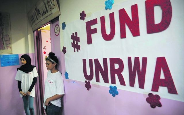 Palestinian students stand outside a classroom at a UNRWA school in Beirut. Photo: AP Photo/Hussein Malla