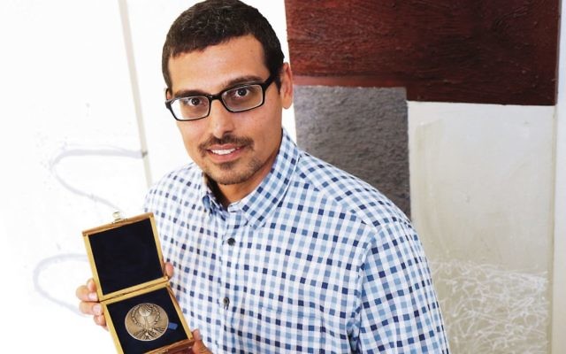 Robert Stroop gave his grandparents' Righteous Among the Nations medal to Manny Waks (pictured holding it) for his courage in addressing the issue of child sexual abuse.  Photo: Peter Haskin