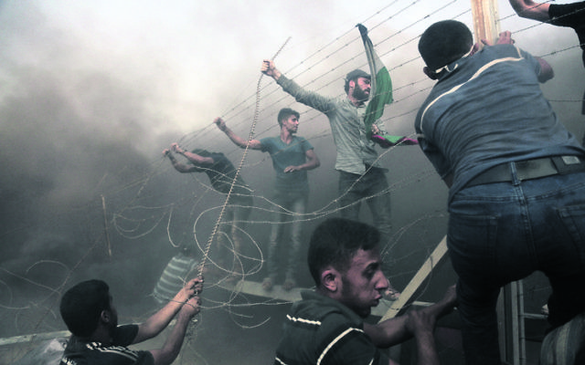 Palestinian demonstrators at the Israel–Gaza border last Friday. Photo: by Majdi Fathi/NurPhoto/Sipa USA
